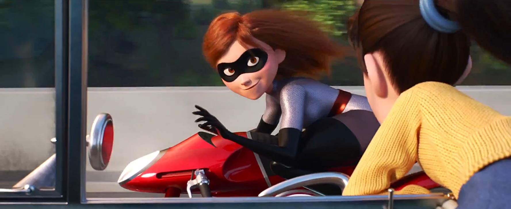 While riding her motorcycle, Elastigirl smiles at a girl in a nearby car before speeding away.
